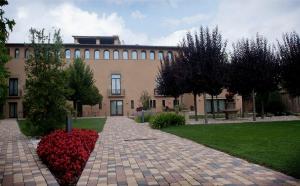 a building with a brick walkway in front of a building at Les Clarisses Boutique Hotel in Vic