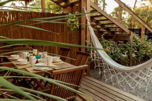 una hamaca en un patio con mesa y sillas en Zulu Beach, en José Ignacio