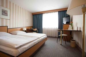Säng eller sängar i ett rum på PP- Hotel Grefrather Hof