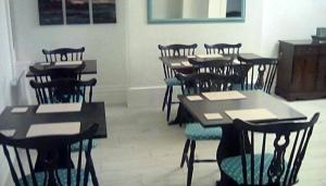 a group of tables and chairs in a room at The braeside families and couples in Blackpool