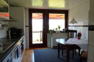 a kitchen with a table and a dining room at Fabys Ferienwohnung in Twielenfleth