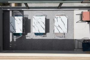 a display case with three chairs and a table at Evripides Hotel in Athens