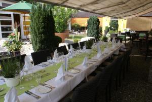 a long table with white plates and glasses on it at Hotel Storchen in Rheinfelden