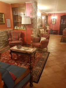 a living room filled with furniture and a table at Hotel Edelweiss in Pré-Saint-Didier