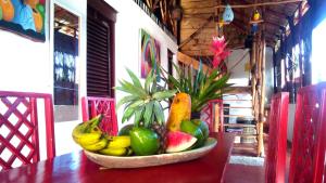 a bowl of fruit sitting on top of a table at Hostel La Ballena Backpacker in Las Galeras