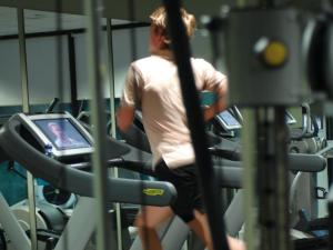 a man running on a treadmill in a gym at Macdonald Hill Valley Hotel Golf & Spa in Whitchurch