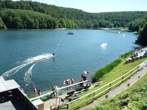 a group of people in a lake with a boat at Ferien-Appartement Goldhausen in Goldhausen +18 photos