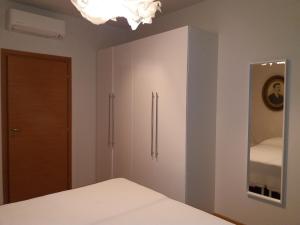 a bedroom with a bed and a cabinet with a mirror at IR Panoramic in Trieste
