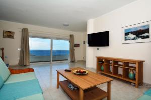 a living room with a couch and a table at Villa hannah - Stunning Sea Views - Roof Terrace in Costa Teguise