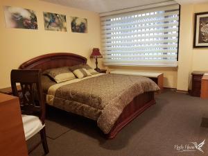 a bedroom with a large bed and a window at Kinde House in Quito