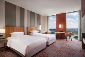 A bed or beds in a room at Hyatt Regency Shanghai Jiading
