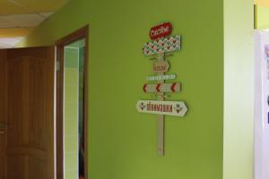 a green wall with street signs on it at HOSTEL Narciss in Novokuznetsk