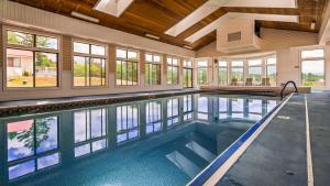 a swimming pool in a house with windows at Best Western White Mountain Inn in Franconia