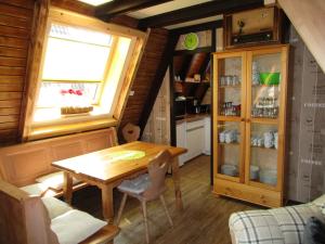 a dining room with a table and a window at Auf die 12 - Auf die 13 in Freyung