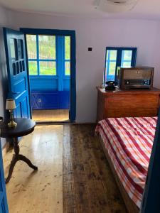 a bedroom with a bed and a blue door at Casa Albastră in Băile Olăneşti