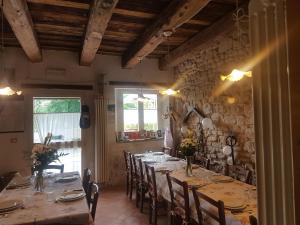 a dining room with a long table and chairs at Agriturismo Piccola Raieda in Sasso Marconi