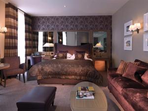 a hotel room with a bed and a couch at Macdonald Windsor in Windsor +67 photos