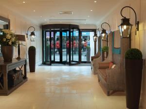 a lobby of a store with a couch and chairs at Macdonald Windsor in Windsor