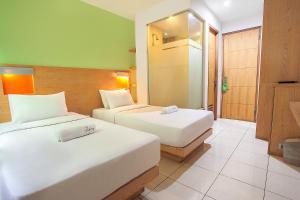 Uma cama ou camas num quarto em LeGreen Suite Poso