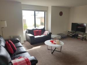 a living room with a couch and a table at Wyndham Luxury - Free Wifi and Netflix in Cowes