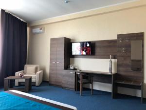 a hotel room with a television on a wall at Kechkemet Hotel in Simferopol