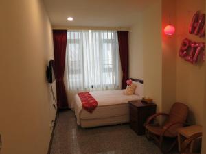 Postel nebo postele na pokoji v ubytování Sun Moon Lake Crown Yu Hotel