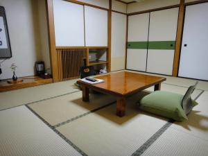 a living room filled with furniture and a table at Kisoya in Gero