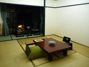 a living room with a couch and a table at Kisoya in Gero