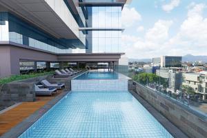 a swimming pool on the roof of a building at YELLO Hotel Paskal Bandung in Bandung