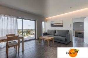
a living room with a couch and a table at Casa Luis Apartments in Santa Eularia des Riu

