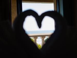 a heart shaped window with a view of a balcony at Pili Pili Beach Cabanas in Sedgefield