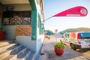 a building with a van parked in front of it at Pili Pili Beach Cabanas in Sedgefield