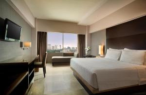 Postel nebo postele na pokoji v ubytování Hotel Santika Premiere Slipi Jakarta