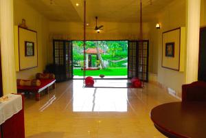a living room with a swing in the middle of a room at Wintergreen Water Front Resort in Tripunnittara