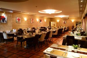 a restaurant with tables, chairs, and tables in it at Larsa Hotel in Amman