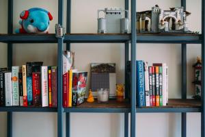 a book shelf with books and toys on it at Kuree Hut in Semporna