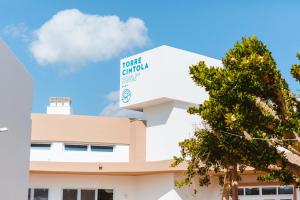 a white building with a sign that reads toronto campus at Torre Cintola Greenblu Sea Emotions in Monopoli