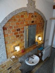 a bathroom with a sink and a brick wall at Villa "Schöni" in Senftenberg +32 photos