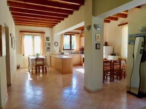 a kitchen and a living room with a table and chairs at Marika's House in Alónai