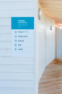 a sign on the side of a wall in a room at Torre Cintola Greenblu Sea Emotions in Monopoli
