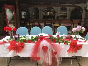 a white table with red bows and flowers on it at Hotel Karyatit Kaleici in Antalya +198 photos