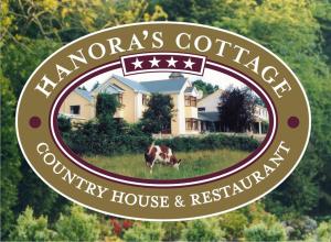 a sign for the farmers cottage country house and restaurant at Hanora's Cottage Guesthouse and Restaurant in Ballymacarbry