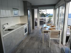 a kitchen with a table and a dining room at Playalaseras in Las Eras