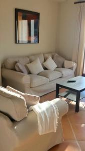 a living room with a couch and a table at Villa 38 in Casares