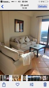 a living room with a couch and a table at Villa 38 in Casares