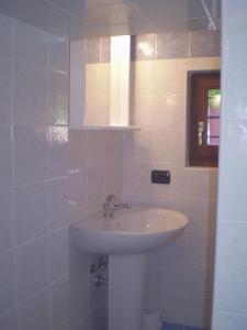 a bathroom with a white sink and a mirror at B&B Renzano bedrooms in Salò +22 photos