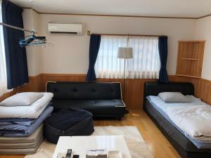 Postel nebo postele na pokoji v ubytování Kurashiki Base Inarimachi