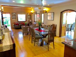 uma sala de jantar e sala de estar com mesa e cadeiras em The Bungalows Light House, Goa by Leisure Hotels em Candolim