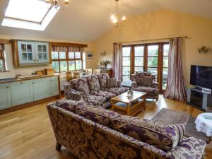 a living room with a couch and a table at Sunny Hill in Penrith
