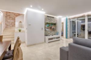 a living room with a couch and a table at Hanami Alcazaba Beach Penthouse in Estepona